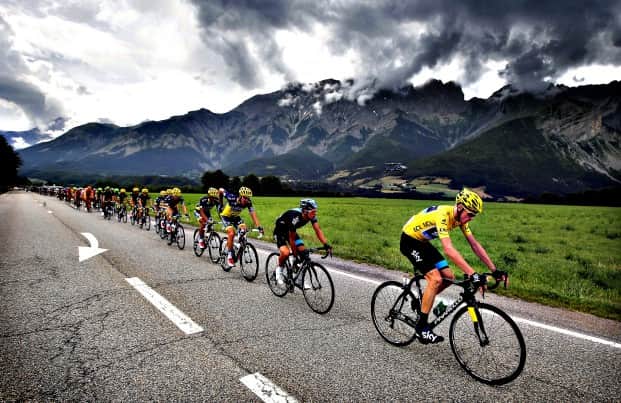 Christopher Froome of Britain, wearing the overall leader's yellow jersey, rides in the pack during the eighteenth stage of the Tour de France cycling race over 172.5 kilometers (107.8 miles) with start in Gap and finish in Alpe-d'Huez, France, Thursday July 18, 2013. (AP Photo/Laurent Cipriani)