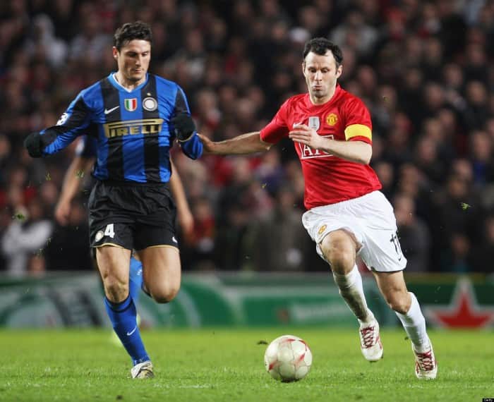 MANCHESTER, ENGLAND - MARCH 11: Ryan Giggs of Manchester United clashes with Javier Zanetti of Inter Milan during the UEFA Champions League First Knockout Round Second Leg match between Manchester United and Inter Milan at Old Trafford on March 11 2009 in Manchester, England. (Photo by John Peters/Manchester United via Getty Images)