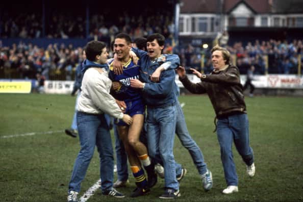 12 March 1988 FA Cup 6th Round - Wimbedon v Watford - Vinnie Jones is mobbed by celebrating Wimbledon fans as they invade the Plough Lane pitch. (Photo by Mark Leech/Getty Images)