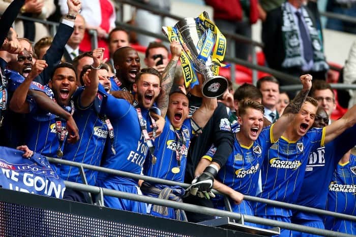 LONDON, ENGLAND - MAY 30: Barry Fuller of Wimbledon lifts the trophy with his teammates after they win the Sky Bet League Two Play Off Final match between Plymouth Argyle and AFC Wimbledon at Wembley Stadium on May 30, 2016 in London, England. (Photo by Jordan Mansfield/Getty Images)