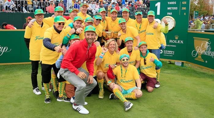 INCHEON CITY , SOUTH KOREA - OCTOBER 11: Dustin Johnson of the United States team stops on his way from the 9th green to the 10th tee to join the 'Fanatics' a group of Australian fans as they pose with the Presidents Cup on the first tee after the last game had teed off during the Sunday singles matches in the 2015 Presidents Cup at the Jack Nicklaus Golf Club Korea on October 11, 2015 in Incheon, South Korea. (Photo by David Cannon/Getty Images)