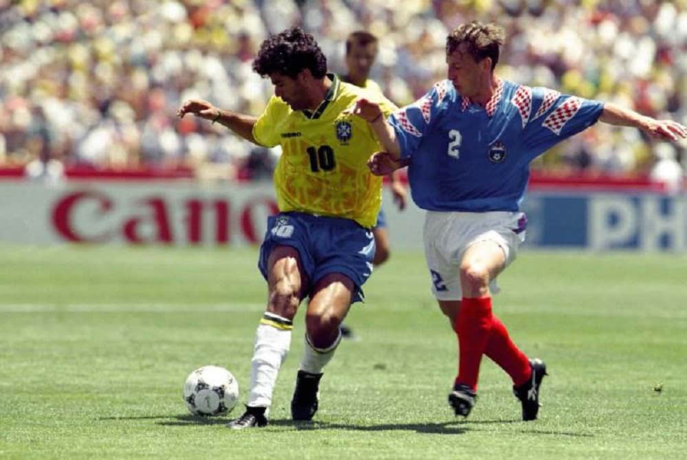 Football - World Cup 1994 , Group B , Boston , Brazil v Russia , 20/6/94 Rai - Brazil in action against Dmitri Kuznetsov - Russia Mandatory Credit:ActionImages / Action Images